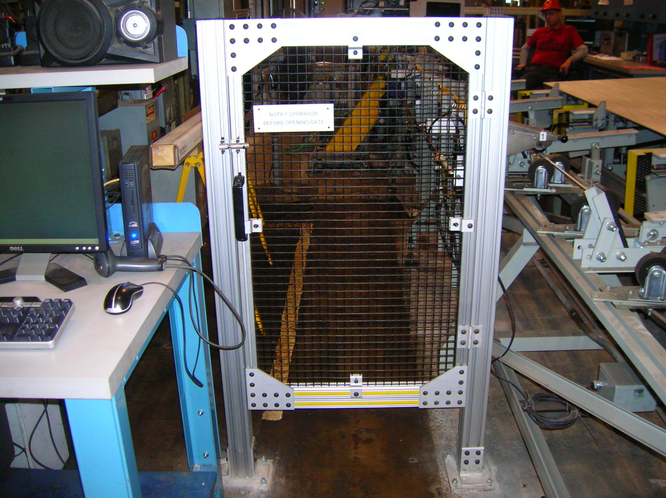 T-slotted aluminum cage surrounding production area